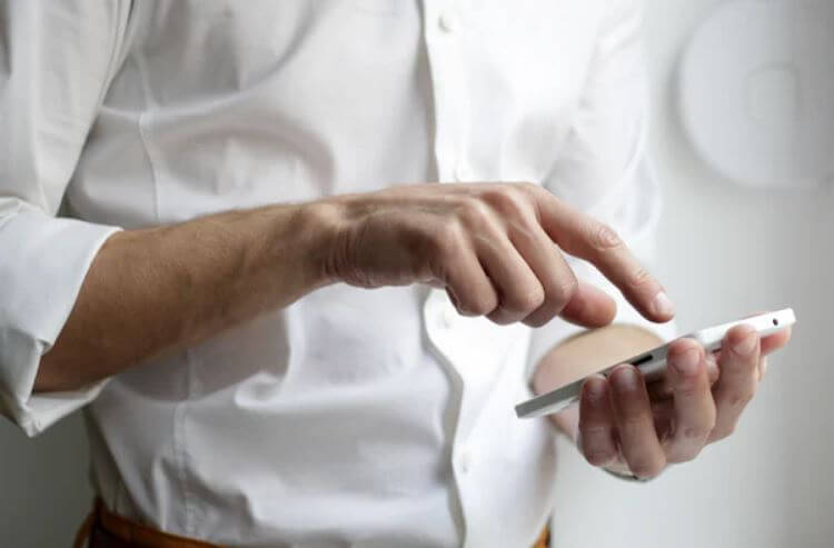 man-pressing-phone